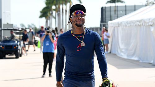 Atlanta Braves right fielder Ronald Acuna Jr. smiles as he walks to the field to take batting practice during spring training workouts at CoolToday Park, Friday, February, 16, 2024, in North Port, Florida. (Hyosub Shin / Hyosub.Shin@ajc.com)