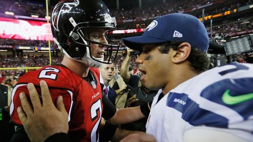 Matt Ryan #2 of the Atlanta Falcons and Russell Wilson #3 of the Seattle Seahawks meet on the field after the Atlanta Falcons win at the Georgia Dome on January 14, 2017 in Atlanta, GA. (Kevin C. Cox/Getty Images/TNS)