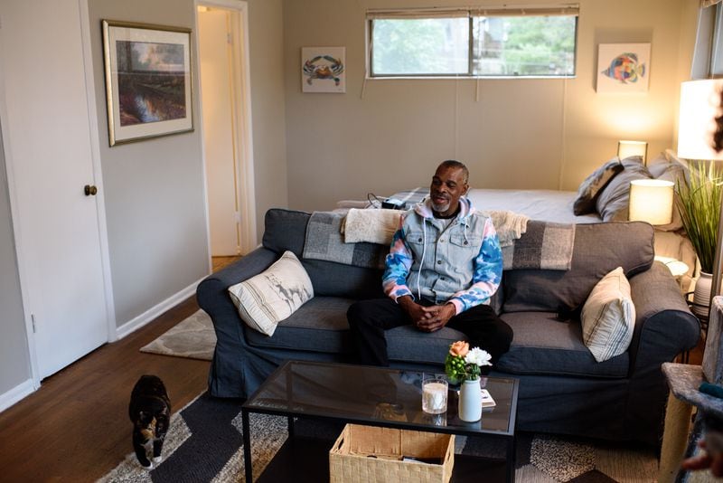Tracey Hardin and his calico cat Patches take in their new apartment. Lynne Dale started a Go Fund Me campaign for formerly homeless Hardin, which raised $35,000.