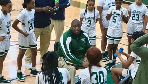Arabia Mountain coach Jerry Jackson talks to his girls basketball team during a timeout.