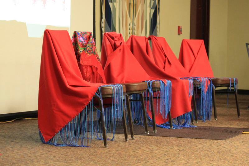 Red shawls drape chairs at the front of the room as families and victim advocates mark Missing and Murdered Indigenous Persons Awareness Day at the Indian Pueblo Cultural Center in Albuquerque, N.M., Sunday, May 5, 2024. The shawls represent relatives who have gone missing or have been killed in what many have described as a crisis in Indian Country. (AP Photo/Susan Montoya Bryan)