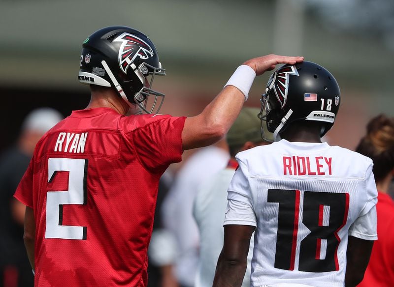 Falcons quarterback Matt Ryan gives wide receiver Calvin Ridley a pat on the helmet after they connected for a touchdown on the fourth day of training camp practice Sunday, Aug. 1, 2021, in Flowery Branch. (Curtis Compton / Curtis.Compton@ajc.com)