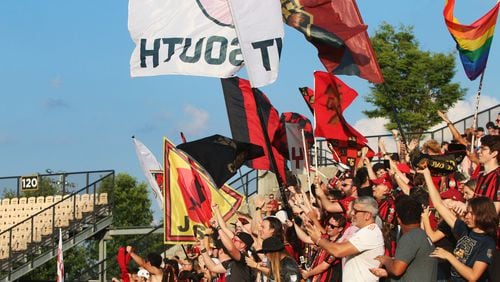 Atlanta United fans wave flags and cheer during a match between Atlanta United and Saint Louis FC at Kennesaw State University. Christina Matacotta/Christina.Matacotta@ajc.com