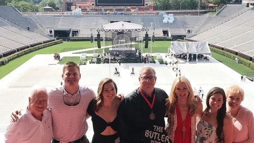 It's graduation day at UGA, Butler style. Kevin Butler, with cap and gown, is joined, from left, by father Joe, son Drew, daughter Savannah, wife Cathy, daughter Scarlett Sugar and mother Sharon. (Photo courtesy of Kevin Butler)