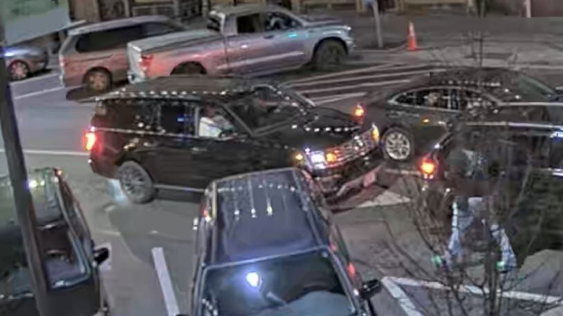 A surveillance camera in downtown Athens captured footage of a rented SUV driven by Chandler LeCroy, a recruiting analyst for the University of Georgia's football team, moments before a fatal crash on Jan. 15. A newly filed lawsuit disputes the university's public statements on events leading to the crash, which killed LeCroy and offensive lineman Devin Willock.