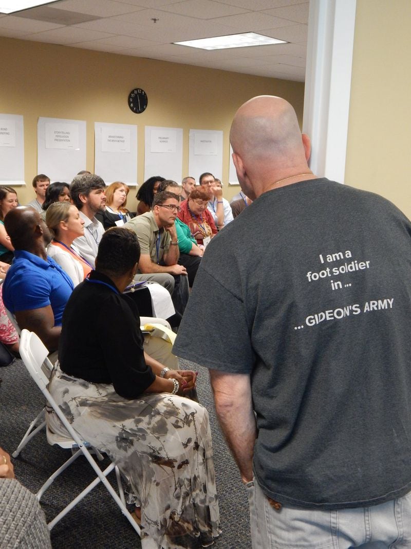 Rapping (right) listens in on a recent Trainer Development session. His T-shirt reads “I am a foot soldier in Gideon’s Army.” Contributed by Gideon’s Promise