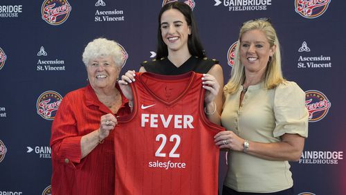 Indiana Fever's Caitlin Clark, middle, poses with general manager Lin Dunn, left, and head coach Christie Sides following a WNBA basketball news conference, Wednesday, April 17, 2024, in Indianapolis. (AP Photo/Darron Cummings)