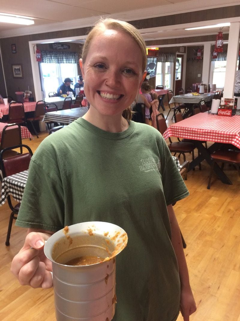 Server Lyndsey Green offers a second (or was it a third?) cup of stew at Bar H Barbecue in Franklin Springs, where refills are free. CONTRIBUTED BY WENDELL BROCK