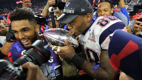 New England’s Martellus Bennett kisses the Lombardi Trophy after the Patriots beat the Falcons 34-28 in the Super Bowl. (Curtis Compton/ccompton@ajc.com)