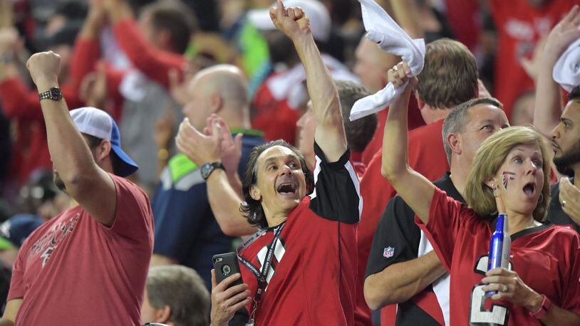 Falcons fans celebrate in the second half during the NFC divisional playoffs at the Georgia Dome on Saturday, January 14, 2017. Atlanta Falcons won 36-20 over the Seattle Seahawks. HYOSUB SHIN / HSHIN@AJC.COM