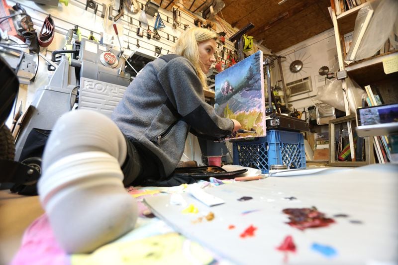 Aimee Copeland works on a painting using a photograph on a computer at the studio of her art teacher, Dawn Kinney Martin, in Midtown Atlanta in February. “Painting for me is more of a creative outlet, for me to express my creativity and discover my creativity through color,” Copeland said. 