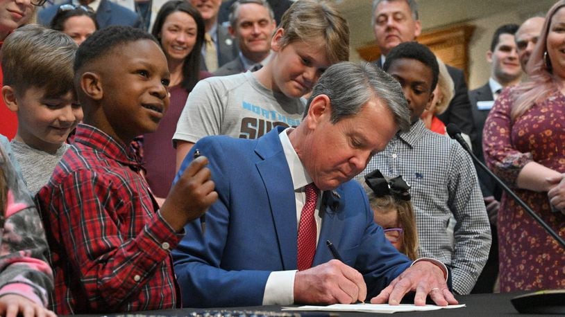 Gov. Brian Kemp signs legislation that allows parents who don’t want their children wearing masks to opt out of any school district mandates at the Georgia State Capitol on Tuesday, March 29, 2022. Gov. Brian Kemp on Tuesday  (Hyosub Shin / Hyosub.Shin@ajc.com)