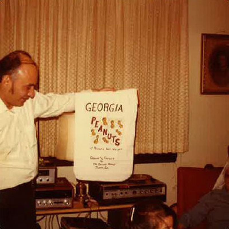 Richard Figueras, father of Atlanta Journal-Constitution Dining Editor Ligaya Figueras, holds the packaging from a gift of Georgia peanuts, one of his favorite snack foods, in this Christmas photo taken in the late 1970s.  LIGAYA FIGUERAS / LIGAYA.FIGUERAS@AJC.COM