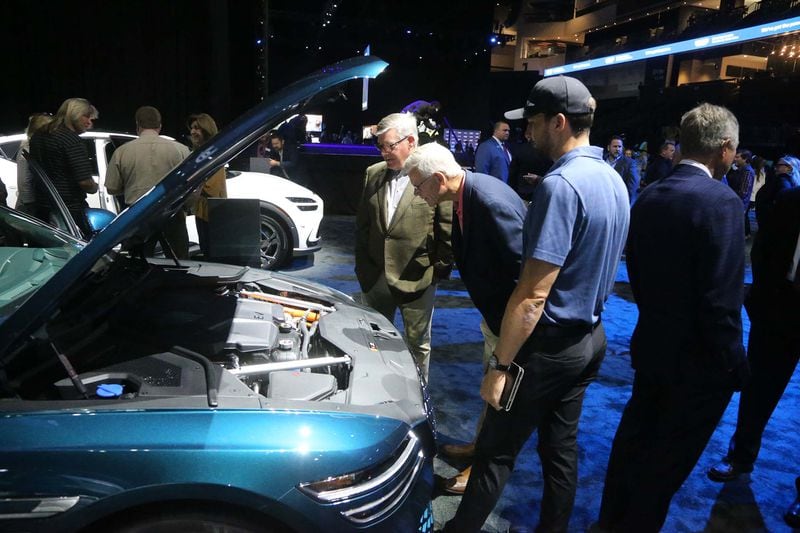 Visitors look under the hood of the Genesis G80 on Tuesday October 25, 2022 during the Hyundai community event at enmarket Arena.