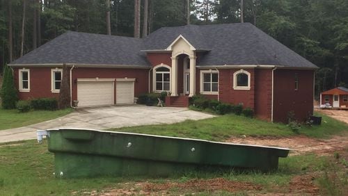 When The Atlanta Journal-Constitution began looking into a federal Paycheck Protection Program loan given to a charity listed at this home in Oxford, Ga., in 2020, an uninstalled swimming pool sat in the front yard. Federal authorities later charged the charity's CEO, Olivia Ware, with using part of a $323,100 PPP loan to pay for the pool, furniture and other home improvement items, as well as paying off her mortgage. JOHNNY EDWARDS / JREDWARDS@AJC.COM