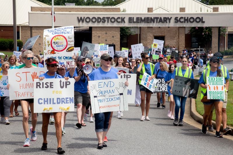 Standing with the Children protesters head out from Woodstock Elementary on their way to the Elm Street Event Green in Woodstock Saturday, August 22, 2020.  STEVE SCHAEFER FOR THE ATLANTA JOURNAL-CONSTITUTION
