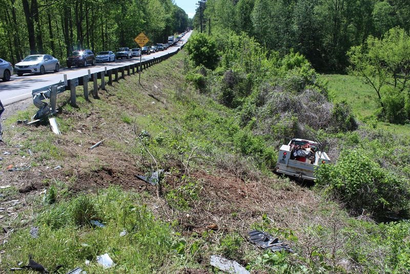 A white Chevrolet truck went down an embankment during a wreck in Ball Ground on Tuesday. (Credit: Cherokee County Fire Department)