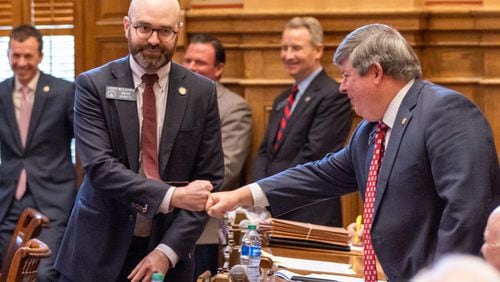 State Sen. Larry Walker III, R-Perry (right), fist bumps Sen. Josh McLaurin, D-Sandy Springs, during a lighter moment of the 2024 legislative session, on March 4, 2024. Walker co-sponsored Senate Bill 390, which sought to banish the influence of the American Library Association. It remained bottled up in the House Higher Education Committee on March 28, the final day of the legislative session. (Arvin Temkar / arvin.temkar@ajc.com)