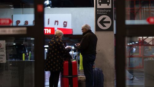 Travelers wait at the designated rideshare area at Hartsfield-Jackson Atlanta International Airport. BRANDEN CAMP/SPECIAL