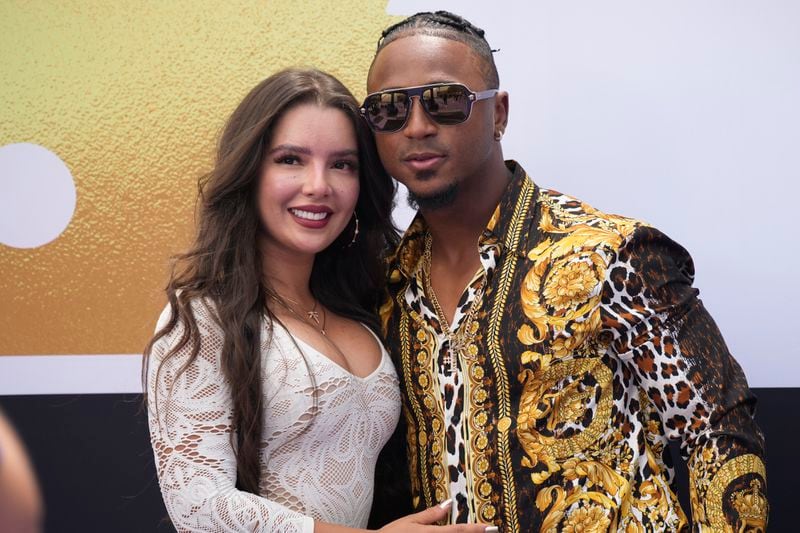 National League's Ozzie Albies, of the Atlanta Braves, arrives at the All Star Red Carpet event with girlfriend Andrea Brazilian Miss prior to the MLB All-Star baseball game, Tuesday, July 13, 2021, in Denver. (AP Photo/David Zalubowski)