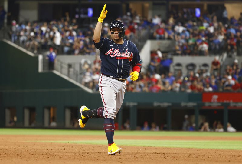 Atlanta Braves' William Contreras reacts after hitting a solo home run, his second of the day, against the Texas Rangers during the sixth inning of a baseball game April 29, 2022, in Arlington, Texas. (AP Photo/Ron Jenkins)