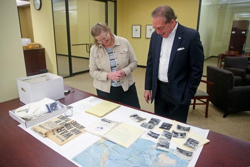 December 5, 2017 - Atlanta, Ga: Cole Harrison, right, of Atlanta, looks over his father's Pearl Harbor memorabilia with Atlanta History Center Director of Oral History and Genealogy Sue VerHoef at the Atlanta History Center Tuesday December 5, 2017, in Atlanta. Harrison's father Nat Harrison was a Pearl Harbor survivor who recorded countless hours of audio recordings documenting his experiences as the Lt. Commander of the USS Sumner, which was based at Pearl Harbor during Japan's surprise attack. Harrison donated his father's memorabilia to the museum. PHOTO / JASON GETZ