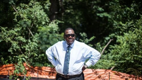 Richard Thomas stands near where members of his family are buried in Atlanta. On Sunday, June 14, 2015, Thomas stopped to visit family graves at Piney Grove Cemetery in Buckhead, only to find the old church site covered in asphalt and new condos under construction. BRANDEN CAMP/SPECIAL