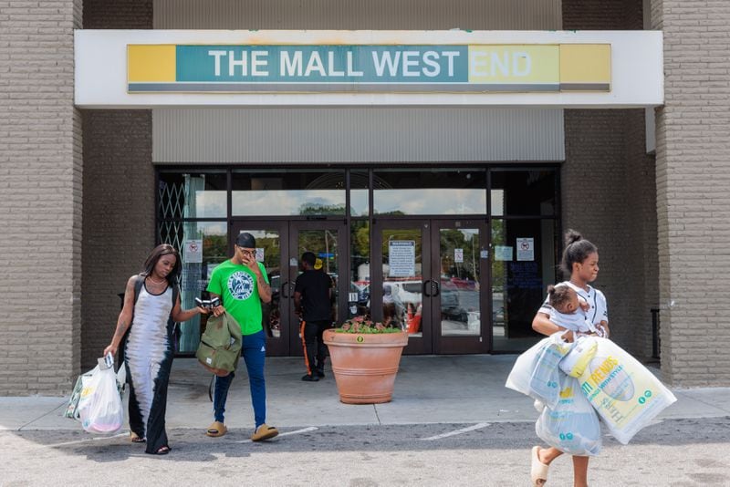 Shoppers exit The Mall West End in Atlanta on Tuesday, August 9, 2022. (Arvin Temkar / arvin.temkar@ajc.com)