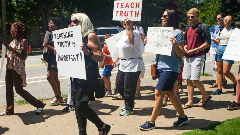 Educators and community members march in July 2022 at Piedmont Park in Atlanta against new state legislative action banning selected books from school libraries and prohibiting the teaching of divisive concepts, related to race, in U.S. history. The Georgia Professional Standards Commission is considering a proposal to scrub the mention of diversity from a state teacher preparation program. (Christina Matacotta for The Atlanta Journal-Constitution)