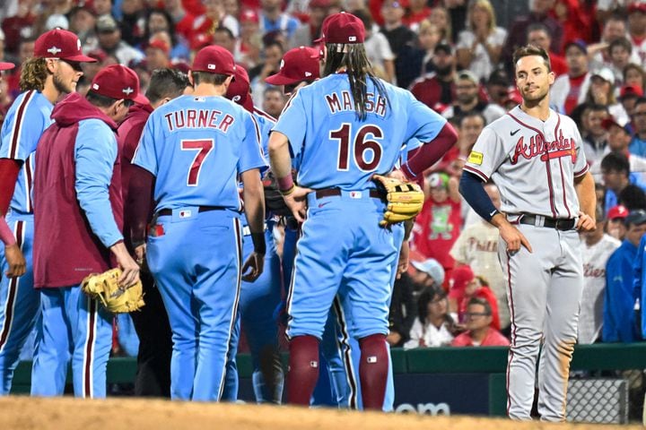 Atlanta Braves’ Matt Olson, right checks in on Philadelphia Phillies first baseman Bryce Harper and Phillies teammates after a collision with Harper during the eighth inning of NLDS Game 4 at Citizens Bank Park in Philadelphia on Thursday, Oct. 12, 2023.   (Hyosub Shin / Hyosub.Shin@ajc.com)
