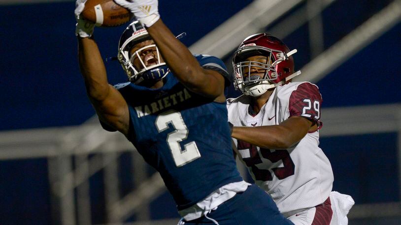 St. Joseph corner back Keenan Nelson Jr. (29) closes in as Marietta wide receiver Arik Gilbert (2) reaches out for a pass in the second half of Friday's game. (Daniel Varnado/Special)