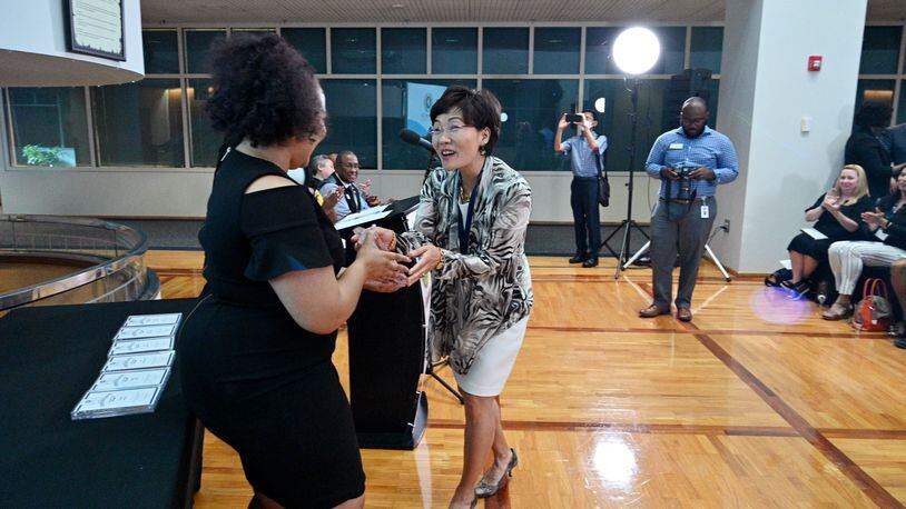 Myeong Hwa Jang reacts as she receives her certificate from Jessica Stewart, left, Community Outreach Program Manager, during Gwinnett 101 Citizens Academy's Spring 2021 graduation ceremony at Gwinnett Justice & Administration Center on Tuesday, June 22, 2021. (Hyosub Shin / Hyosub.Shin@ajc.com)