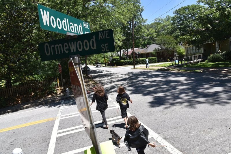 Children’s author Laurel Snyder and her sons, Mose, 11, and Lewis (foreground), 10, walk back home in their Ormewood Park neighborhood. All of the kids in her book “Charlie and Mouse” are real people, who live up and down Woodland Avenue. HYOSUB SHIN / HSHIN@AJC.COM