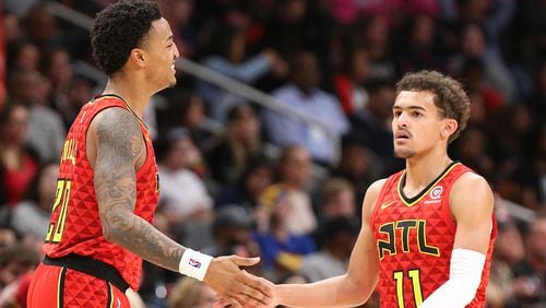 Atlanta Hawks guard Trae Young gets five from John Collins in the final minutes of a 106-82 victory over the Miami Heat in a NBA basketball game at State Farm Arena on Sunday,  Jan. 6, 2019, in Atlanta.   Curtis Compton/ccompton@ajc.com