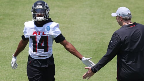 Falcons wide receiver Russell Gage (14), wearing a new jersey number, is congratulated by head coach Arthur Smith after catching a pass during organize team activities (OTAs) Tuesday, May 25, 2021, at the team training facility in Flowery Branch. (Curtis Compton / Curtis.Compton@ajc.com)