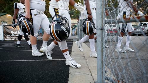 Colquitt County players before the start of Friday's game. (Casey Sykes for The Atlanta Journal-Constitution)