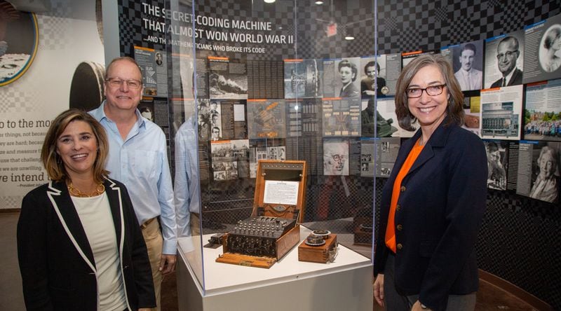 Karin (from left) and Lonnie Mimms pose next to an Enigma machine with Executive Director Rena Youngblood at the Computer Museum of America in Roswell. PHIL SKINNER FOR THE ATLANTA JOURNAL-CONSTITUTION.