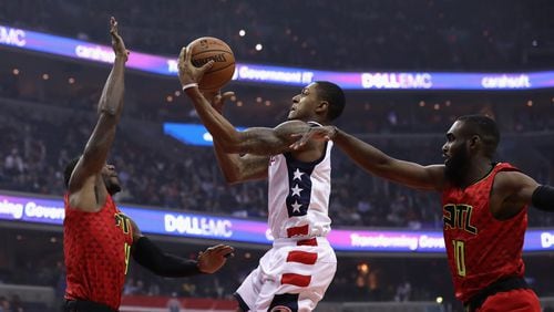 Bradley Beal of the Washington Wizards puts up a shot in front of Paul Millsap (left) and Tim Hardaway Jr. (right) of the Atlanta Hawks in the first half during Game 5 of the Eastern Conference Quarterfinals during the 2017 NBA Playoffs at at Verizon Center on April 26, 2017 in Washington, DC. (Photo by Rob Carr/Getty Images)