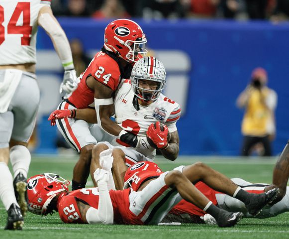 Ohio State Buckeyes wide receiver Emeka Egbuka (2) completes a 19 yard pass from quarterback C.J. Stroud (7) during the second quarter of the College Football Playoff Semifinal between the Georgia Bulldogs and the Ohio State Buckeyes at the Chick-fil-A Peach Bowl In Atlanta on Saturday, Dec. 31, 2022. (Jason Getz / Jason.Getz@ajc.com)