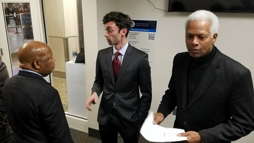 Jon Ossoff, center, is flanked by Georgia Reps. John Lewis and Hank Johnson at Atlanta's airport.