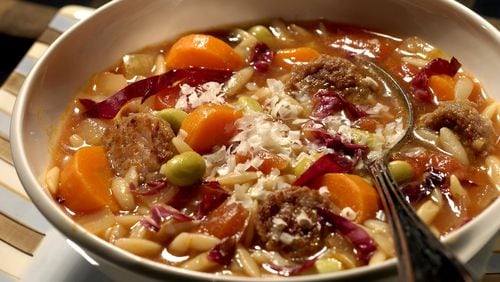 A refrigerator rich with odds and ends is the source for this soup, built on smoked turkey sausage, carrots, onion, tomatoes, pasta and edamame. (Chicago Tribune/TNS)
