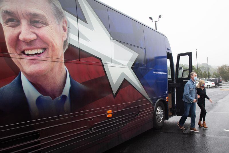  Senator David Perdue exits his bus at the canvass kick-off event in Marietta Saturday, October 10, 2020 STEVE SCHAEFER / SPECIAL TO THE AJC 