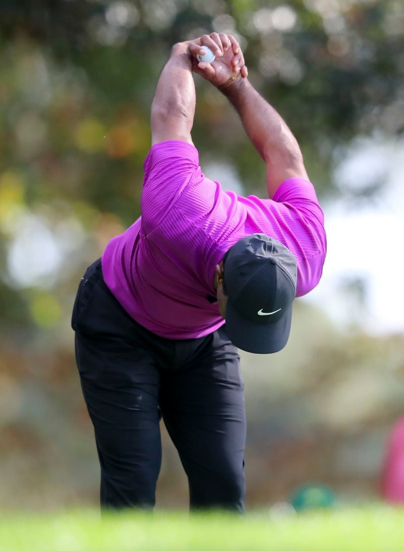 Tiger Woods stretches on the fourth tee during the third round of the Masters at Augusta National Golf Club on Saturday, Nov 14, 2020, in Augusta.    (Curtis Compton / Curtis.Compton@ajc.com)  