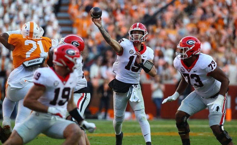 Georgia quarterback Carson Back makes a first down pass completion on a scoring drive against Tennessee during the first quarter on the way to taking a 10-7 lead in a NCAA college football game on Saturday, Nov. 18, 2023, in Knoxville.  Curtis Compton for the Atlanta Journal Constitution