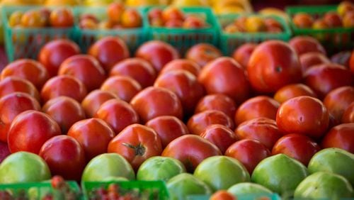 A wide range of different tomatoes are shown at Mountain Earth Farms, of Clarksville, Ga., during the Roswell Farmes and Artisans Market  in 2018. PHOTO / JASON GETZ