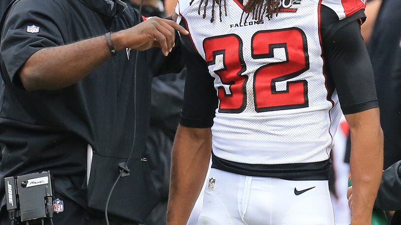 102515 NASHVILLE: -- Falcons cornerback Jalen Collins gets coached up on the sidelines between plays against the Titans in a football game on Sunday, Oct. 25, 2015, in Nashville. It was his first NFL start. Curtis Compton / ccompton@ajc.com