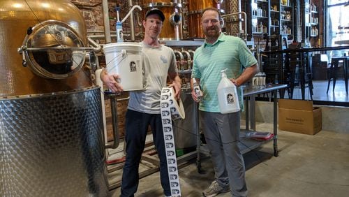 Brothers Jeff (left) and Craig Moore of Atlanta’s Old Fourth Distillery found themselves in a surprising new line, pivoting from distilled spirits to hand sanitizer. CONTRIBUTED BY JEFF MOORE
