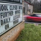 School closings came quickly as COVID-19 started taking hold in Georgia in March 2020. This sign at Murphey Candler Elementary School in Lithonia, DeKalb County, shared the message on Wednesday, March 18, 2020. (John Spink / John.Spink@ajc.com)