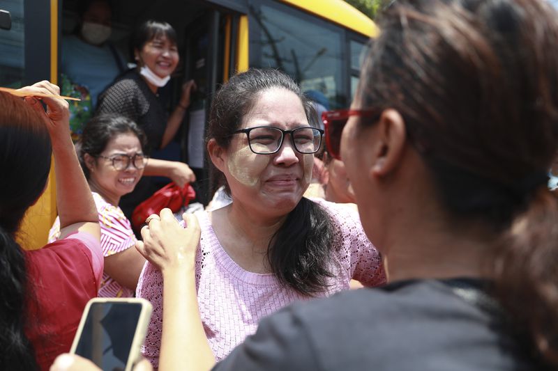 A released prisoner is welcomed by family members and colleagues after she was released from Insein Prison Wednesday, April 17, 2024, in Yangon, Myanmar. On Wednesday Myanmar's military government granted amnesty for over 3,000 prisoners to mark this week’s traditional New Year holiday. (AP Photo/Thein Zaw)
