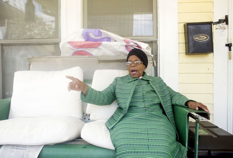 Helene Mills, 90, a lifelong resident of Atlanta’s Old Fourth Ward, sits on the porch of her yellow bungalow. The new neighbors who have arrived with the Beltline’s luxury construction rarely talk to her or visit. But the community activist recalls how residents in past decades banded together to revive the historically black neighborhood. CHAD RHYM/ CHAD.RHYM@AJC.COM